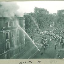 Aerial view of spectators and fire fighting at the Chemisty Building, The University of Iowa, October 23, 1953