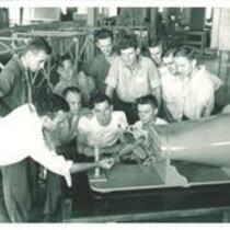 Aerodynamics class examining a model plane, The University of Iowa, 1940s