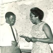 Esther Walls and Femi Oyewole in front of Nigerian map, Nigeria, August 1964
