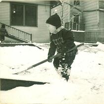 Child shoveling snow, The University of Iowa, January 1938